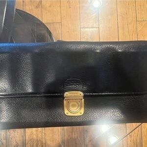 Black leather Salvatore Ferragamo wallet with gold buckle.